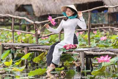 Side view of young woman using mobile phone