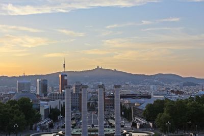 View of cityscape against cloudy sky