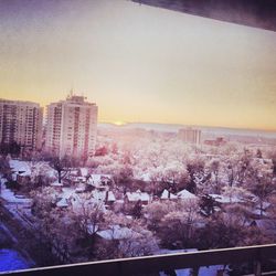 Cityscape against sky at sunset