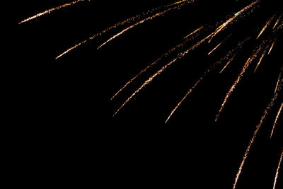 Low angle view of firework display against sky at night