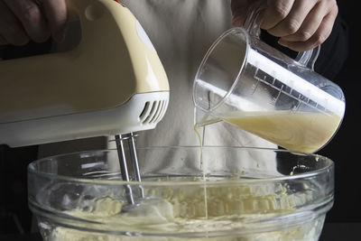 Close-up of hand pouring water in glass