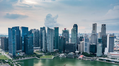 Aerial view of buildings in city against sky