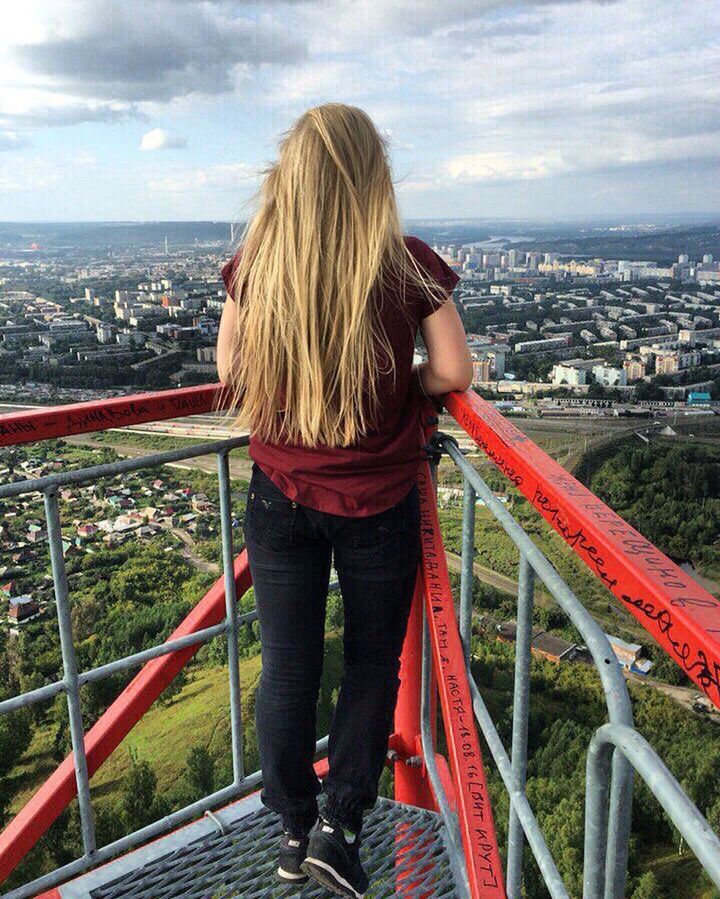 railing, rear view, cityscape, city, sky, casual clothing, standing, leisure activity, long hair, person, looking at view, tourist, cloud - sky, city life, blond hair, straight hair, observation point, outdoors, scenics, vacations