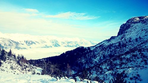 Scenic view of snow covered mountains against sky