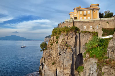 View of castle on mountain against cloudy sky