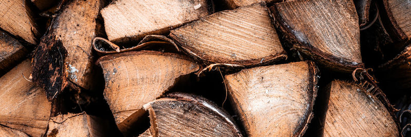 Textured firewood background of chopped wood for kindling and heating the house. a woodpile