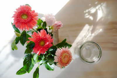 Close-up of flowers in glass on table
