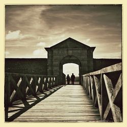 People walking on pier