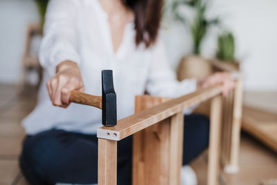 Woman sitting on wooden table