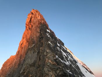 Low angle view of rock formation against clear sky