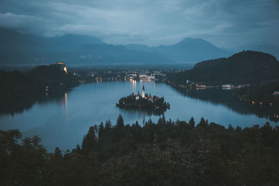 Scenic view of lake and mountains against sky