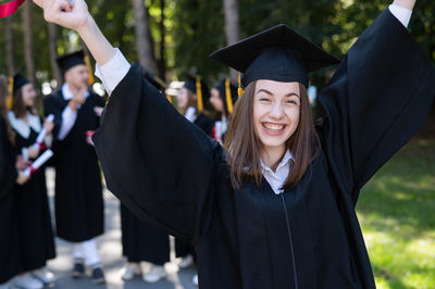 Young woman wearing graduation gown