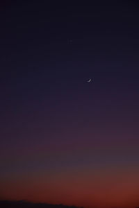 Low angle view of moon in sky at night