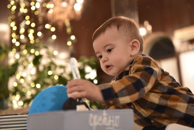 Full length of boy with illuminated christmas tree