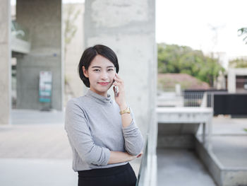 Portrait of young woman talking on phone