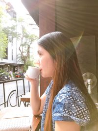 Young woman drinking coffee cup