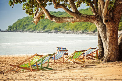 View of chairs on beach against sea