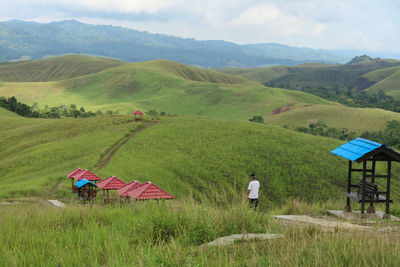 Scenic view of field and mountains against sky