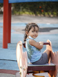 Portrait of girl sitting outdoors