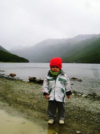 Boy standing against sky