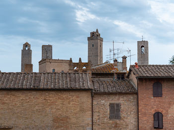 Details of bell towers and brick houses in san gimignano in tuscany, siena - italy.