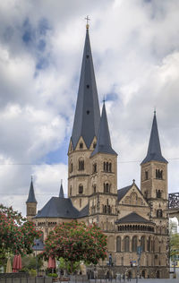 View of buildings in city against cloudy sky