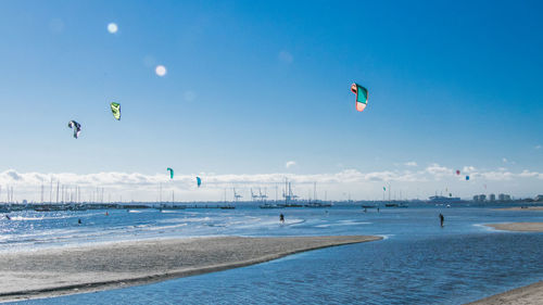 Scenic view of beach against blue sky