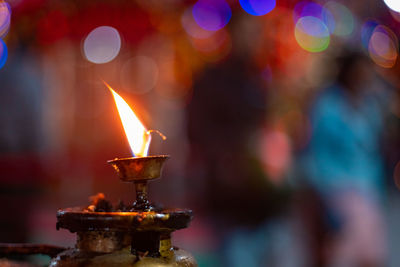 Close-up of lit candles in temple