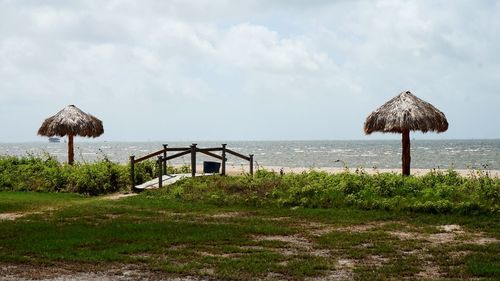 Lifeguard hut on beach against sky