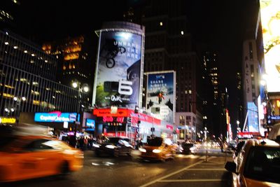 Cars on illuminated city at night