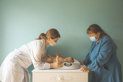 Side view of young woman holding hands on table