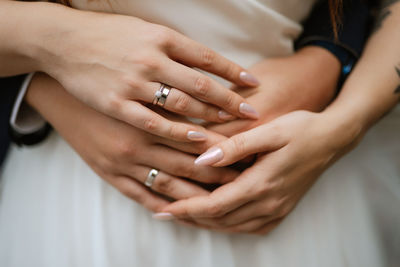 Midsection of couple holding hands