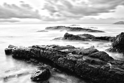 Scenic view of sea against cloudy sky