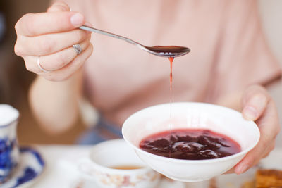 Close-up of hand holding drink in bowl