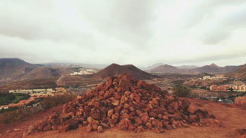 Scenic view of mountains against cloudy sky