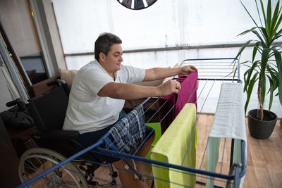 Side view of man sitting on wheelchair