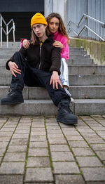 Portrait of young woman sitting on staircase