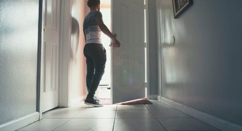 Rear view of man standing in corridor