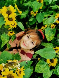 Portrait of smiling girl with leaves on plant