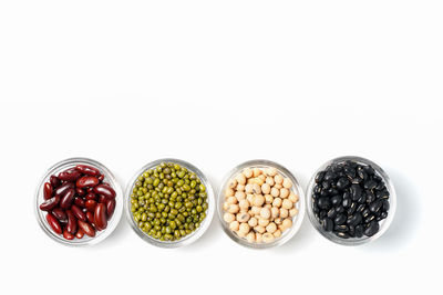 Various fruits in bowl against white background