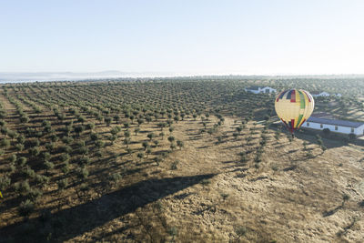 High angle view of hot air balloon on field against sky