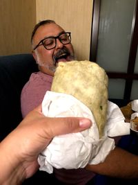 Portrait of man holding ice cream at home