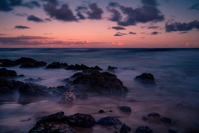 Scenic view of sea against sky at sunset