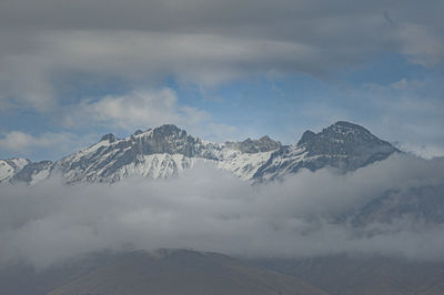 The chachani volcano seen in the middle of clouds that surround it in the city of arequipa