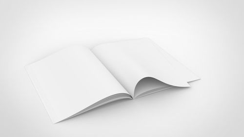 High angle view of open book against white background