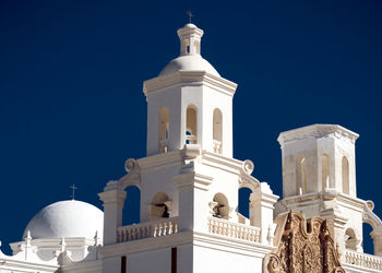 Low angle view of mosque against clear blue sky