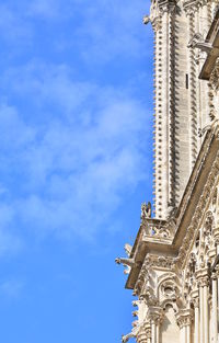 Low angle view of bell tower against blue sky