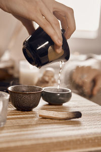 Cropped hands of person preparing food on table