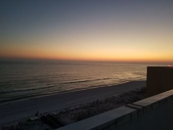 Scenic view of sea against clear sky during sunset