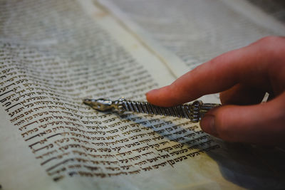 Close-up of hand holding book